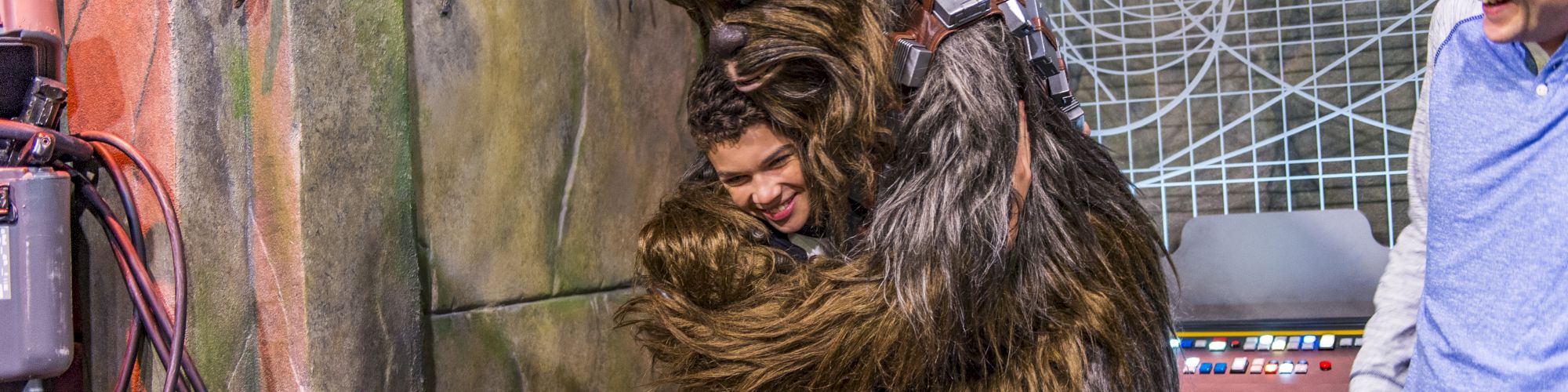 Chewbaca hugging child at DISNEYLAND® Resort